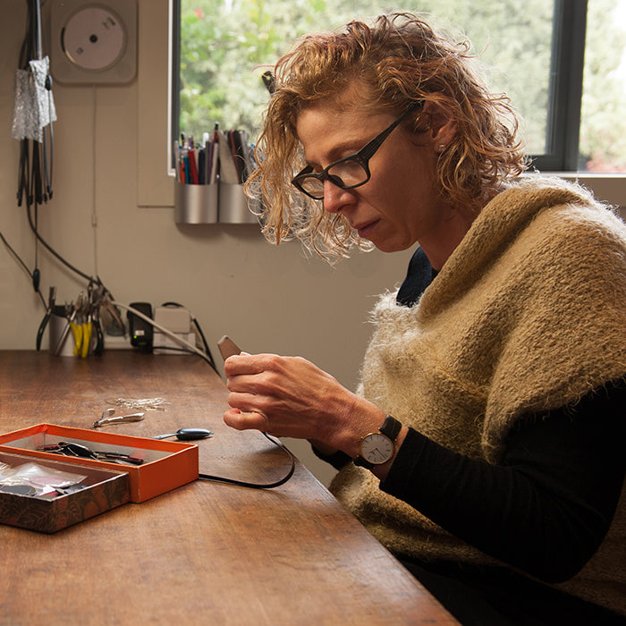 Iris Saar Isaacs hand-finishing jewellery in the inSync design Melbourne studio.
