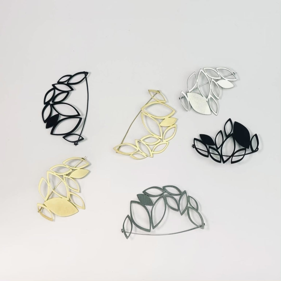 X2 Stillness Brooch Set in gold, black and raw stainless steel in presented different combinations.