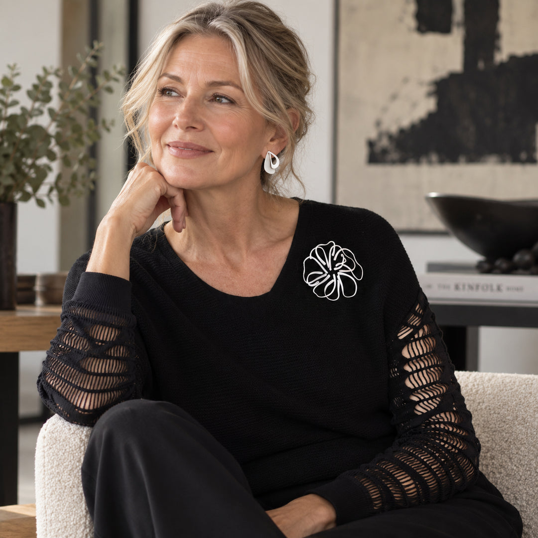 woman wearing stainless steel stud earrings and brooch
